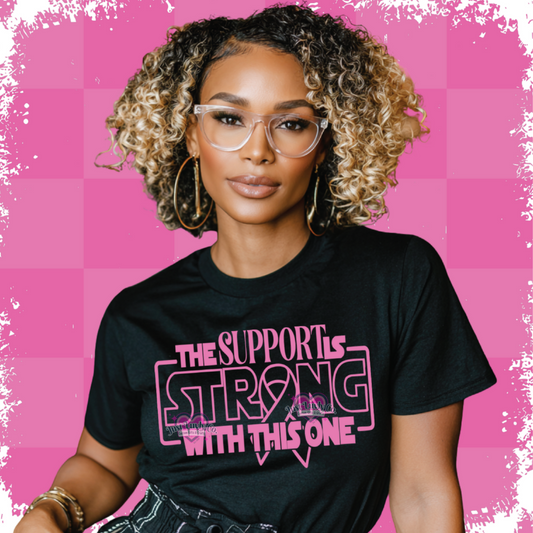 Woman wearing a black t-shirt with pink text on a pink background