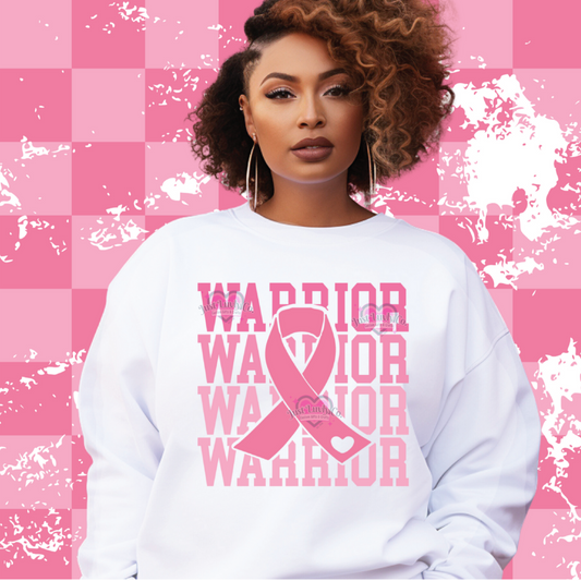 Woman wearing a white sweatshirt with 'Warrior' text and pink ribbon design on a pink checkered background