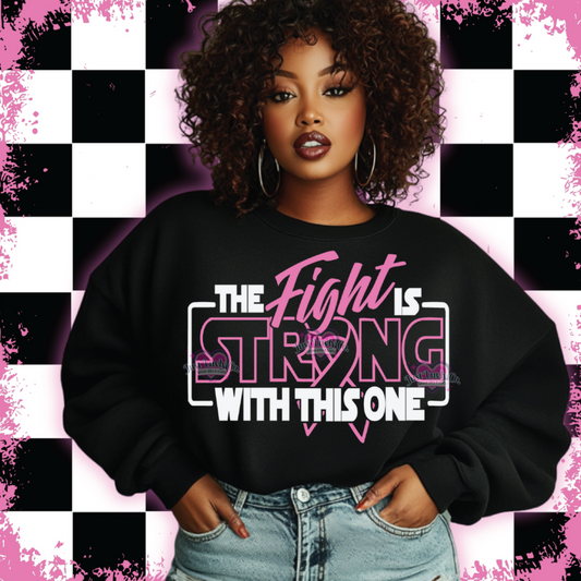 Woman wearing a black sweatshirt with 'The Fight is Strong With This One' text, standing against a checkered background.